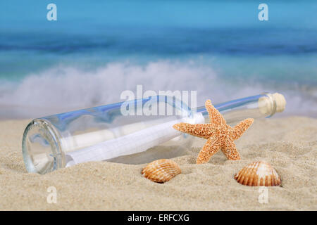 Beach scene in summer on vacation with bottle post and copyspace Stock Photo