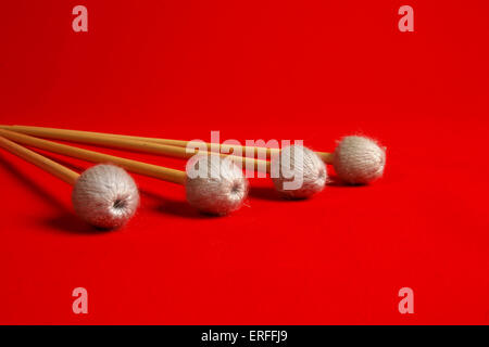 Vibraphone mallets / beaters / sticks red background Stock Photo