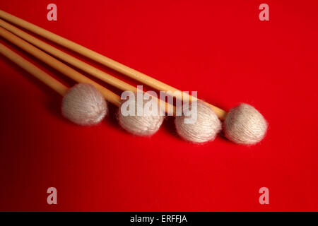 Vibraphone mallets / beaters / sticks red background Stock Photo