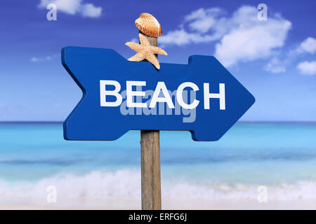 Sign to the sandy beach and sea in summer on vacation Stock Photo