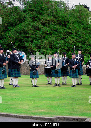 Scottish Pipe Band - a band performing outdoors, playing bagpipes and drums, and wearing kilts. Bagpipe player.  Bagpiper. Stock Photo