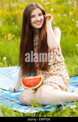 Young beautiful woman eating a watermelon Stock Photo