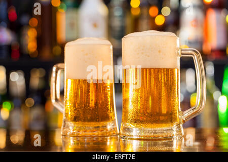 Jugs of beer placed on bar counter with copyspace Stock Photo