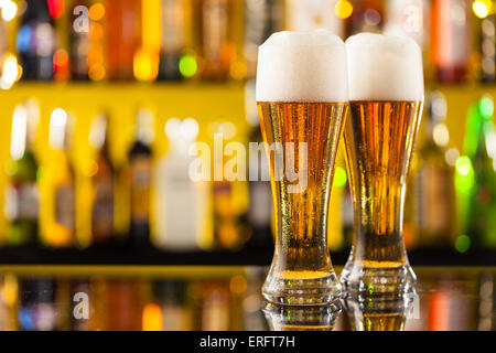 Jugs of beer placed on bar counter with copyspace Stock Photo
