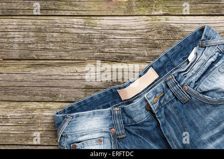 Jeans on wooden background Stock Photo