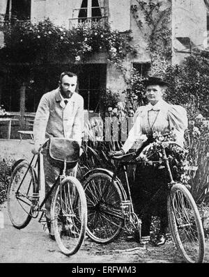 Pierre and Marie Curie with the bicycles on which, during their early married life, the roamed the roads of France together. MC: Polish-born French physicist and pioneer in radioactivity, 7 November 1867 – 4 July 1934. PC: French physicist and pioneer in radioactivity, 15 May 1859 – 19 April 1906. Stock Photo