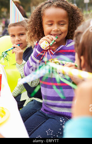 Girl With Blower At Outdoor Birthday Party Stock Photo - Alamy