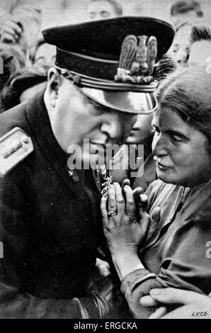 Benito Mussolini listening to woman - portrait. 40th Prime Minister of Italy and leader of National Fascist Party: 29 July 1883 Stock Photo