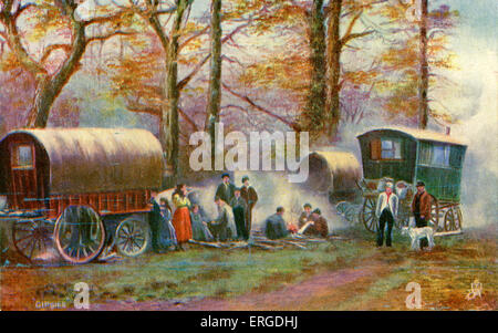 Gypsy camp in the countryside. Shows gypsies gathered round a fire, with caravans. Stock Photo