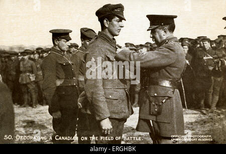 World War 1: Canadian soldier being decorated on the battle field. Receiving a war medal. British Official War Photograph Stock Photo