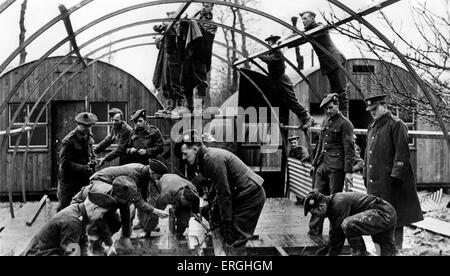 World War 2: Auxiliary Military Pioneer Corps in France. Caption: 'Preparing for the arrival of the new army. Many of these men fought in the last war. Many have sons in the army, but they are still determined to help. These men are constructing army huts'. British Army combatant corps used for light engineering tasks. Raised on 17 October 1939, renamed the Pioneer Corps on 22 November 1940. Postcard issued by Ministry of Information. War Office Photograph No.B.1490. Stock Photo