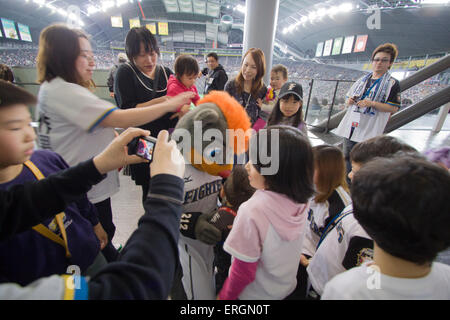 Children gather to have their photo taken with BB, the mascot of the Hokkaido Nippon Ham Fighters professional baseball team Stock Photo