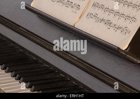 Old, classical, music, and vintage piano and scores. Concept of old, classical, music played on vintage acoustic instrument. Stock Photo