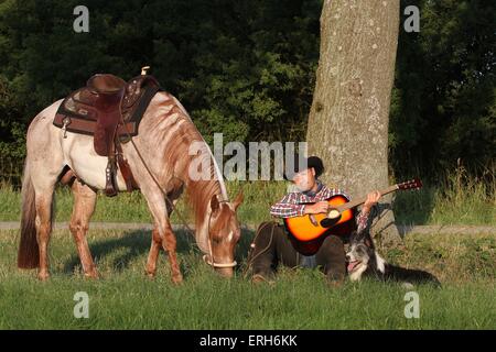 man with dog and horse Stock Photo