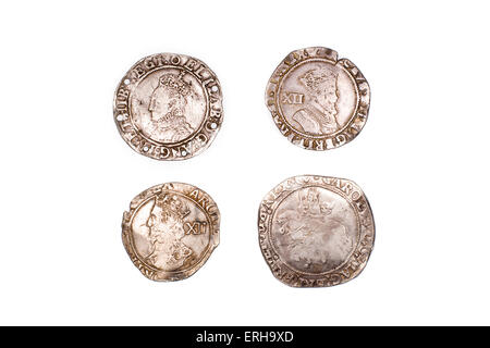 A lot of old silver coins with portraits of kings on a white background Stock Photo