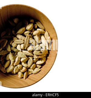 Cardamom in a wooden bowl Stock Photo