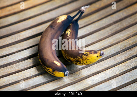 two overripe bananas on wood Stock Photo