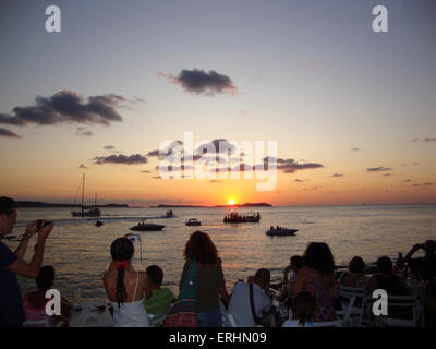 Friends watching the sun set outside cafe mambo Ibiza Stock Photo