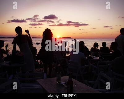 Friends watching the sun set outside cafe mambo Ibiza Stock Photo