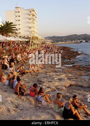 Crowds line the beach watching the sun set outside cafe mambo Ibiza Stock Photo