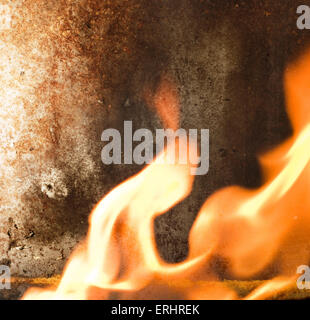 Rusty metal texture and flames of fire around it Stock Photo