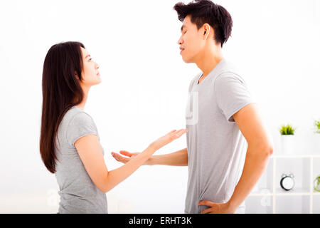 Angry young couple arguing in living room Stock Photo