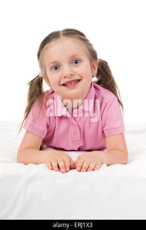 portrait girl in pink dress in bed Stock Photo
