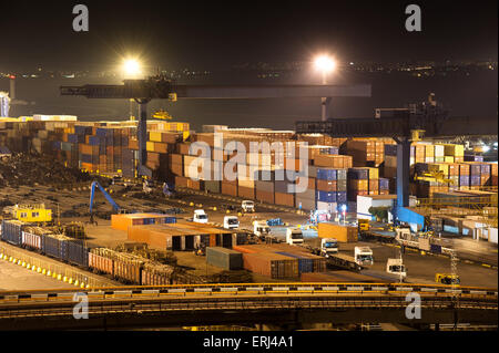 night industrial port.  containers and trucks Stock Photo