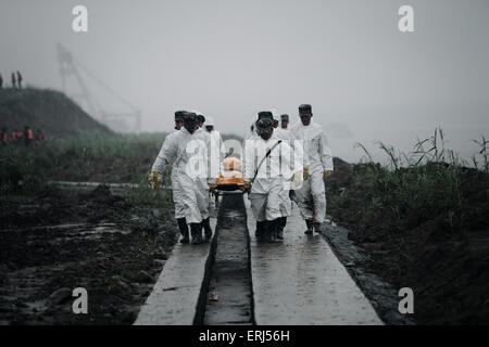 Jianli, China. 03rd June, 2015. Rescuers carry the body of a victim fund from the sank ship 'Eastern Star' on the bank of the Yangtze River in Jianli county, Hubei province, central China, 3th June 2015. The ship, Carrying 406 passengers, five travel agency workers and 47 crew members,sank at around 9:28 p.m. (1328 GMT) on Monday,  according to the Xinhua News Agencey Said. Credit:  Panda Eye/Alamy Live News Stock Photo
