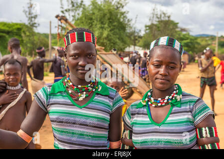 Two girls from the Hamar tribe with traditional jewelry at a popular local market. Stock Photo