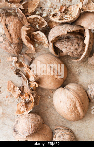 broken walnuts on a wooden table Stock Photo