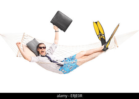 Happy businessman lying in a hammock and gesturing joy with his hands isolated on white background Stock Photo