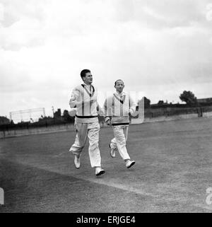 Australian tour of Great Britain for the Ashes. Australian cricketers Keith Miller (left) and Lindsay Hassett jogging around the practice ground ahead of the third test match against England at old Trafford.  22nd July 1953. Stock Photo