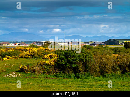 View across the airfield at RAF Valley in Anglesey North Wales UK with the Snowdonia mountain range visible in the distance Stock Photo
