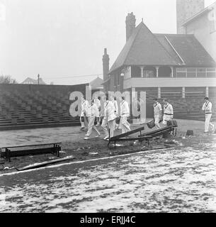 Yorkshire County Cricket Club, players head to the practice shed with snow still on the ground, 5th April 1961. Stock Photo