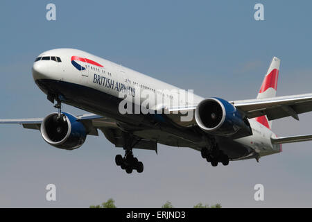British Airways Boeing 777-300ER twin-engine long-haul commercial jet plane on approach. Close up front view emphasising size of aircraft and engines. Stock Photo