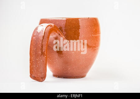 Old clay cup isolated on white background. Stock Photo