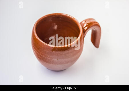 Old clay cup isolated on white background. Stock Photo