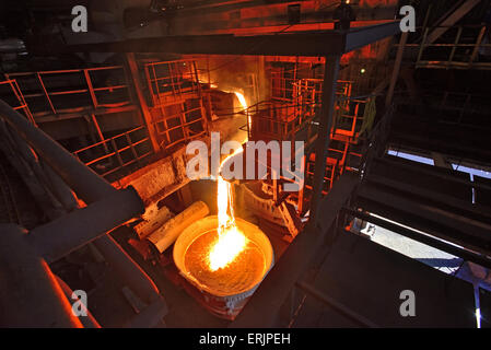 Liquid iron from the ladle inside of steel plant Stock Photo