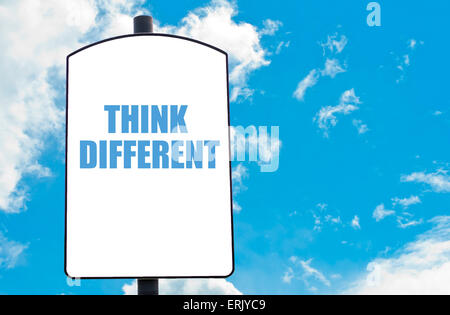 Think Different motivational quote written on white road sign isolated over clear blue sky background. Concept image with available copy space Stock Photo
