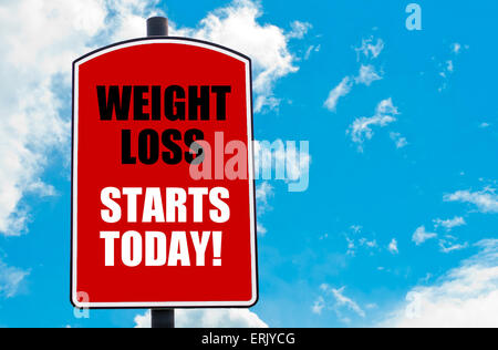 Weight Loss Starts Today motivational quote written on red road sign isolated over clear blue sky background. Concept image with available copy space Stock Photo