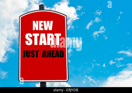 New Start Just Ahead motivational quote written on red road sign isolated over clear blue sky background. Concept image with available copy space Stock Photo
