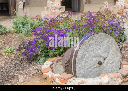 Olive Mill grinding stone at 'Mission San Juan Capistrano' with ruins, museum, and rehabilitation in progress. Stock Photo