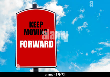 Keep Moving Forward  motivational quote written on red road sign isolated over clear blue sky background. Stock Photo