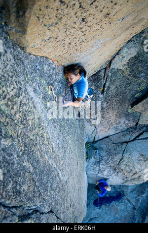 High angle perspective of an a woman climbing on a granite wall. Stock Photo