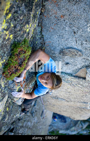 High angle perspective of an a  woman climbing on a granite wall. Stock Photo