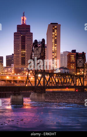 Ice covered Mississippi River and St. Paul skyline with railroad bridge at dusk. Stock Photo