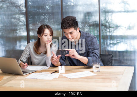 IT workers developing smart phone Stock Photo