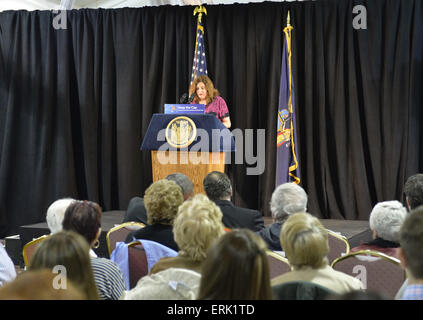 Seaford, New York, USA. 3rd June, 2015. MARIA BRENNAN, of Wantagh, speaks at an event supporting extension of the NY Property Tax Cap. Brennan explained how prior to the tax cap her taxes increased 10% in one year, and how high taxes are concern to family members she'd like to join her in Long Island. At the bi-partisan event at Knights of Columbus Hall, over a hundred area residents and officials, urged extending the property tax cap before the state legislative session ends on June 17. The NY Property Tax Cap is set to expire June 2016, but is legally linked to NYC rent-control reg Stock Photo