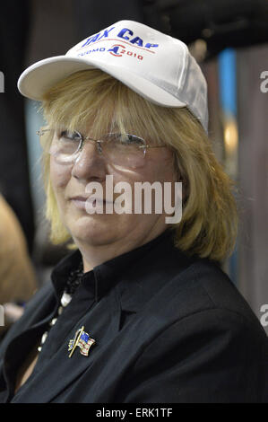 Seaford, New York, USA. 3rd June, 2015. CLAUDIA BORECKY, of Merrick, the Democratic candidate for Legislator of Nassau County Legislature District 19, wears a cap with TAX CAP CUOMO 2010 written on it at an event supporting extension of the NY Property Tax Cap. At the bi-partisan event at Knights of Columbus Hall, over a hundred area residents and officials, and the governor, urged extending the property tax cap before the state legislative session ends on June 17. The NY Property Tax Cap is set to expire June 2016, but is legally linked to NYC rent-control regulations set to expire Stock Photo